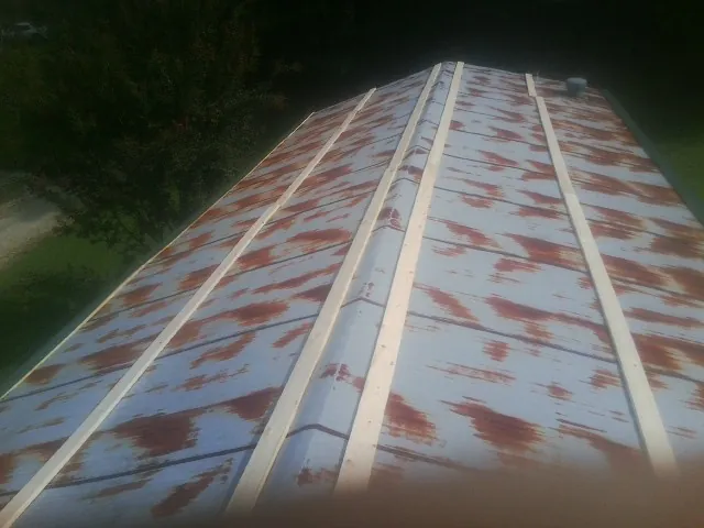 Rusted metal roof panels with new wood purlins before replacement — Storm Damage Roof Repair in Enfield by Roofing Brothers