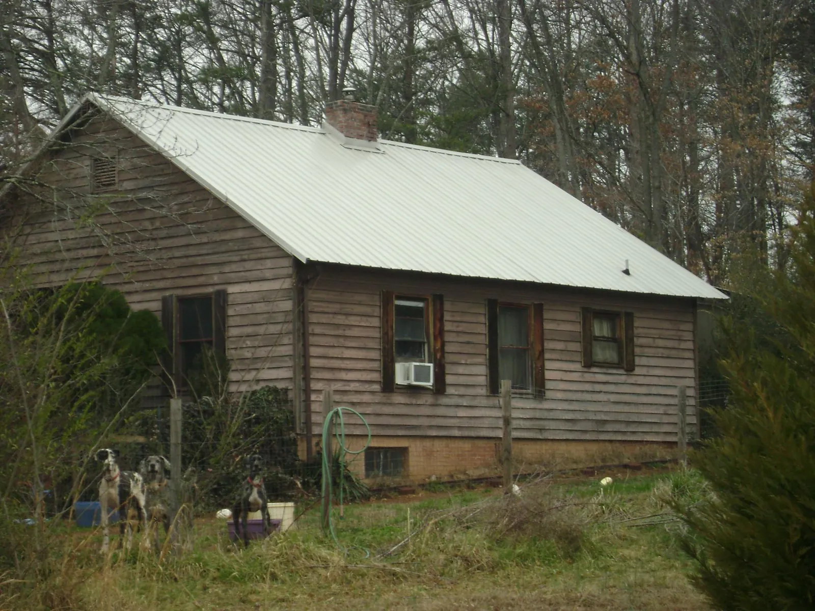 White metal roof on an old wood sided farmhouse, from a Metal Roof Installation job in Enfield